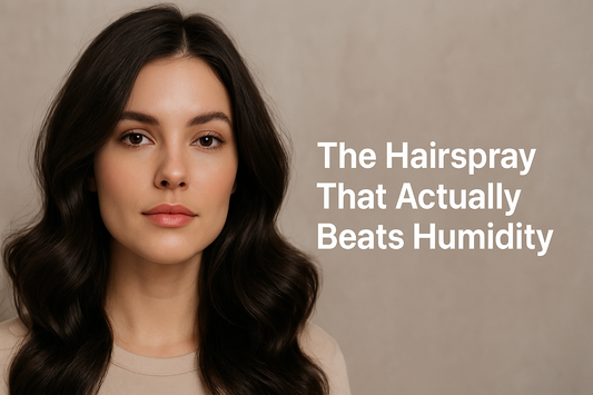 Close-up of a woman with long wavy dark hair and natural makeup, with text on the right that reads 'The Hairspray That Actually Beats Humidity' against a neutral background.